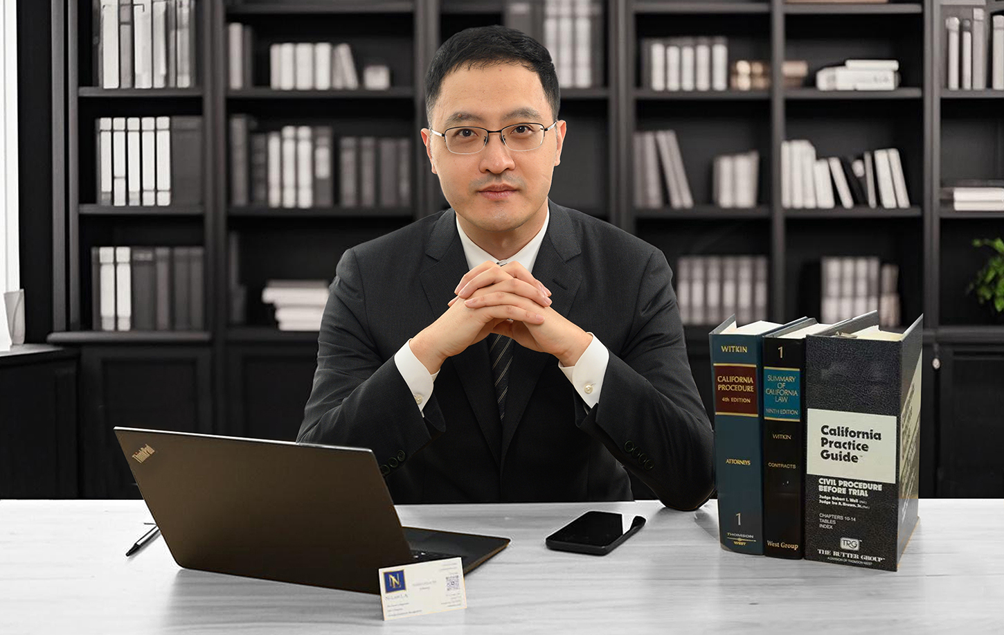 Mr. Yunfei (Alan) Ni, Chief Counsel of Ni Law, sitting at his desk with folded hands.