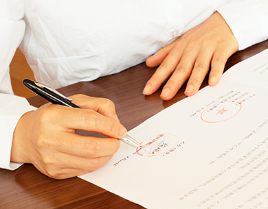 A woman attorney signing a contract dispute.